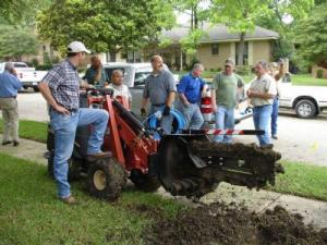 to speed up installs our Coral Gables sprinkler installation team uses a large trencher 